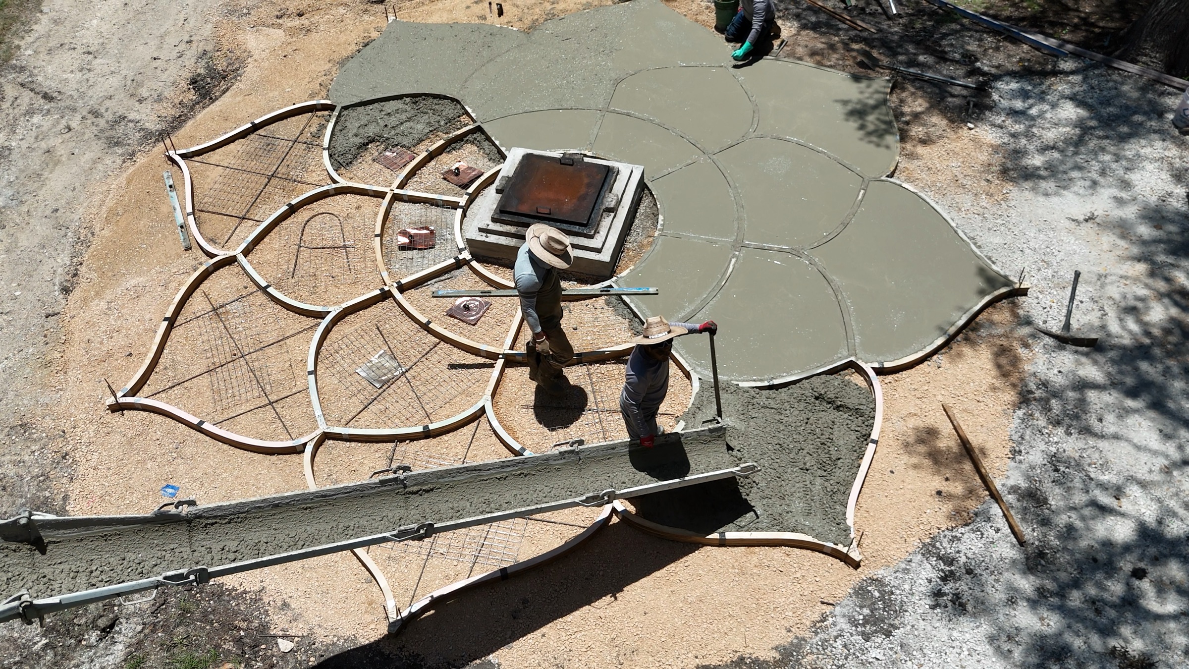The crew working concrete from the chute into the petal forms.