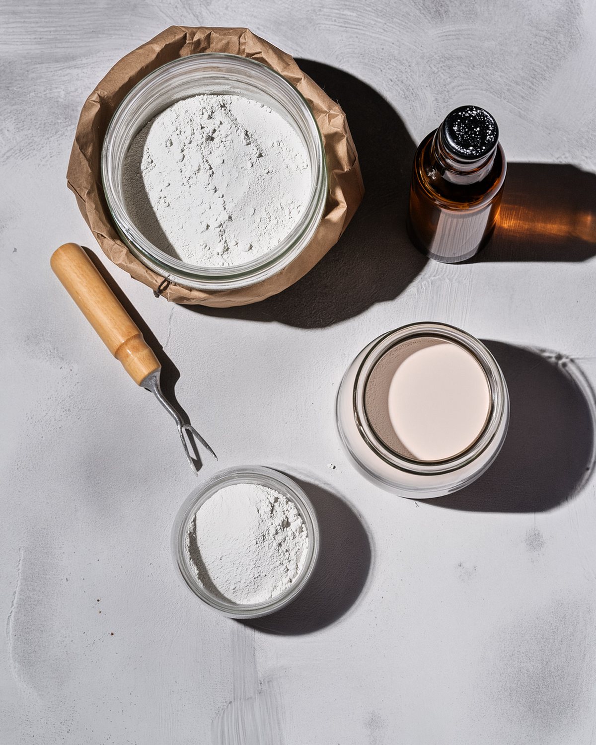 The marble face kit laid out on a bench: white portland cement, marble flour, metakaolin, superplasticizer