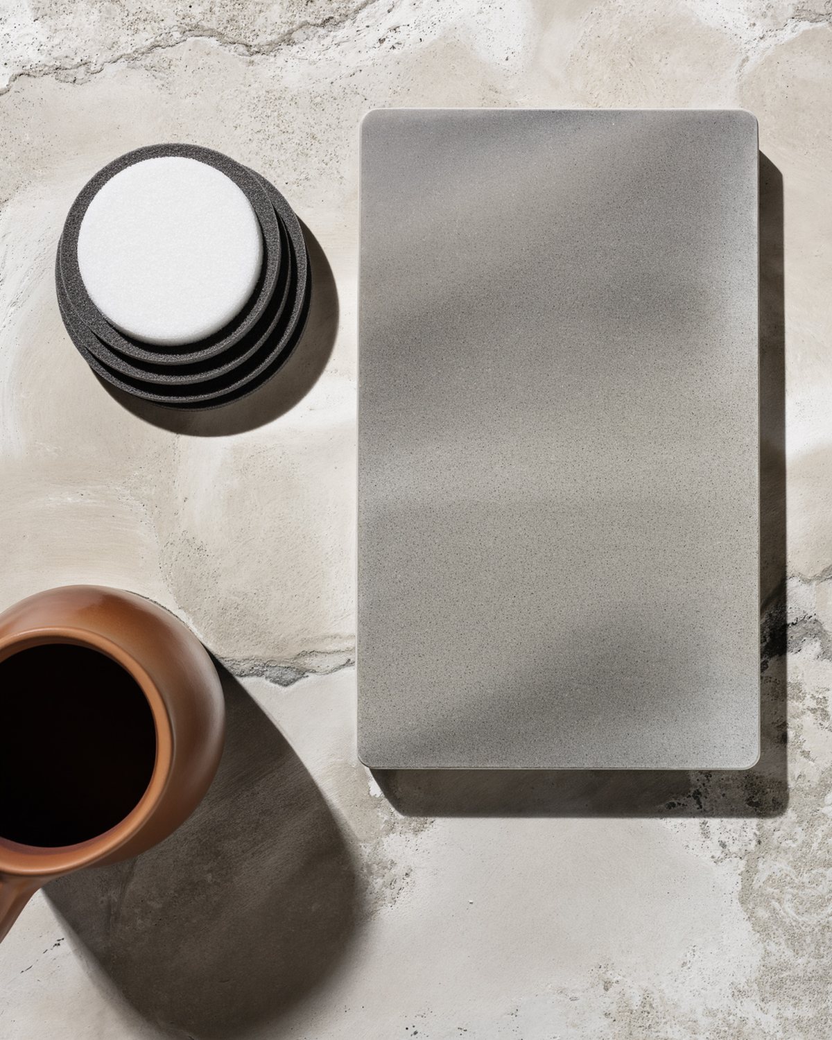 The polished floor kit laid out on a bench: lithium silicate densifier, diamond tooling, guard and burnish