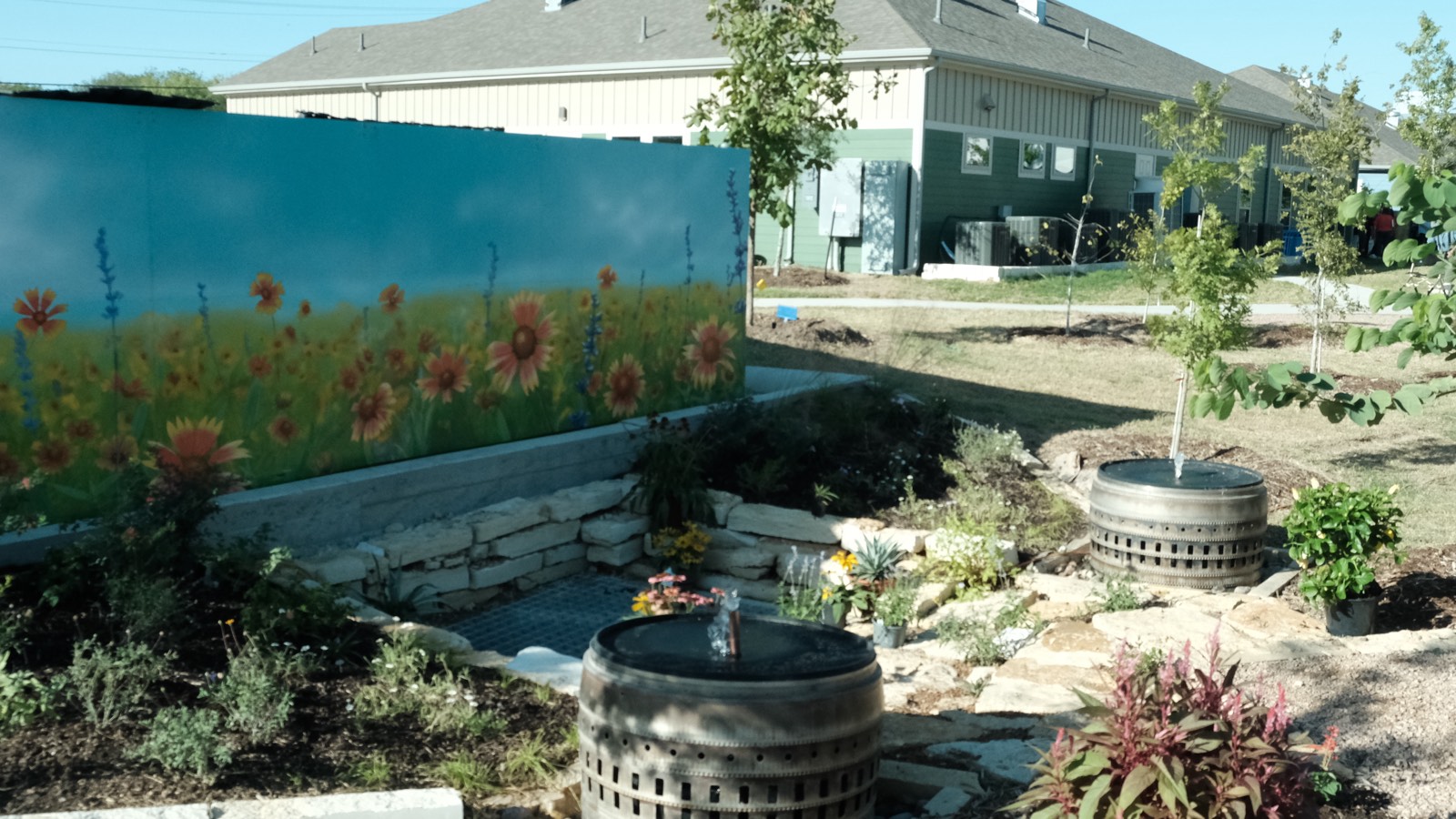 The closed-loop water garden Noon built at a supportive senior community in San Antonio — recirculating fountains, wildflower mural, native plantings