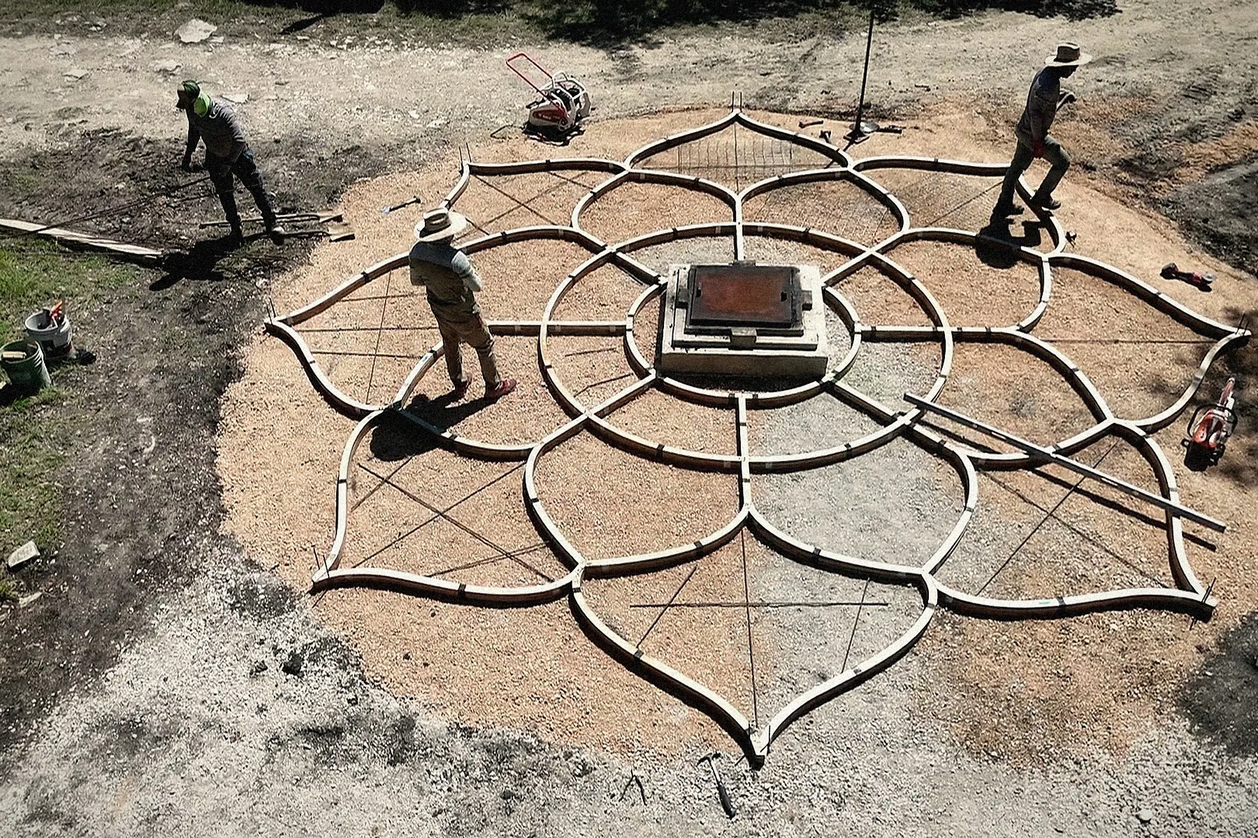 The Lotus forms set on the prepared ground, the crew working inside them.