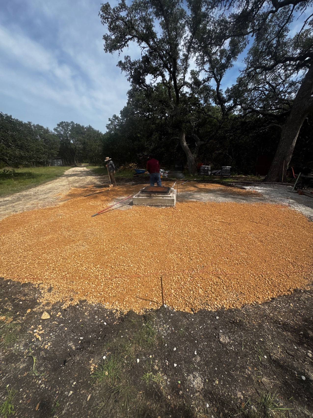 The prepared decomposed-granite base for the Lotus under live oaks at the Hill Country site, before the pour.