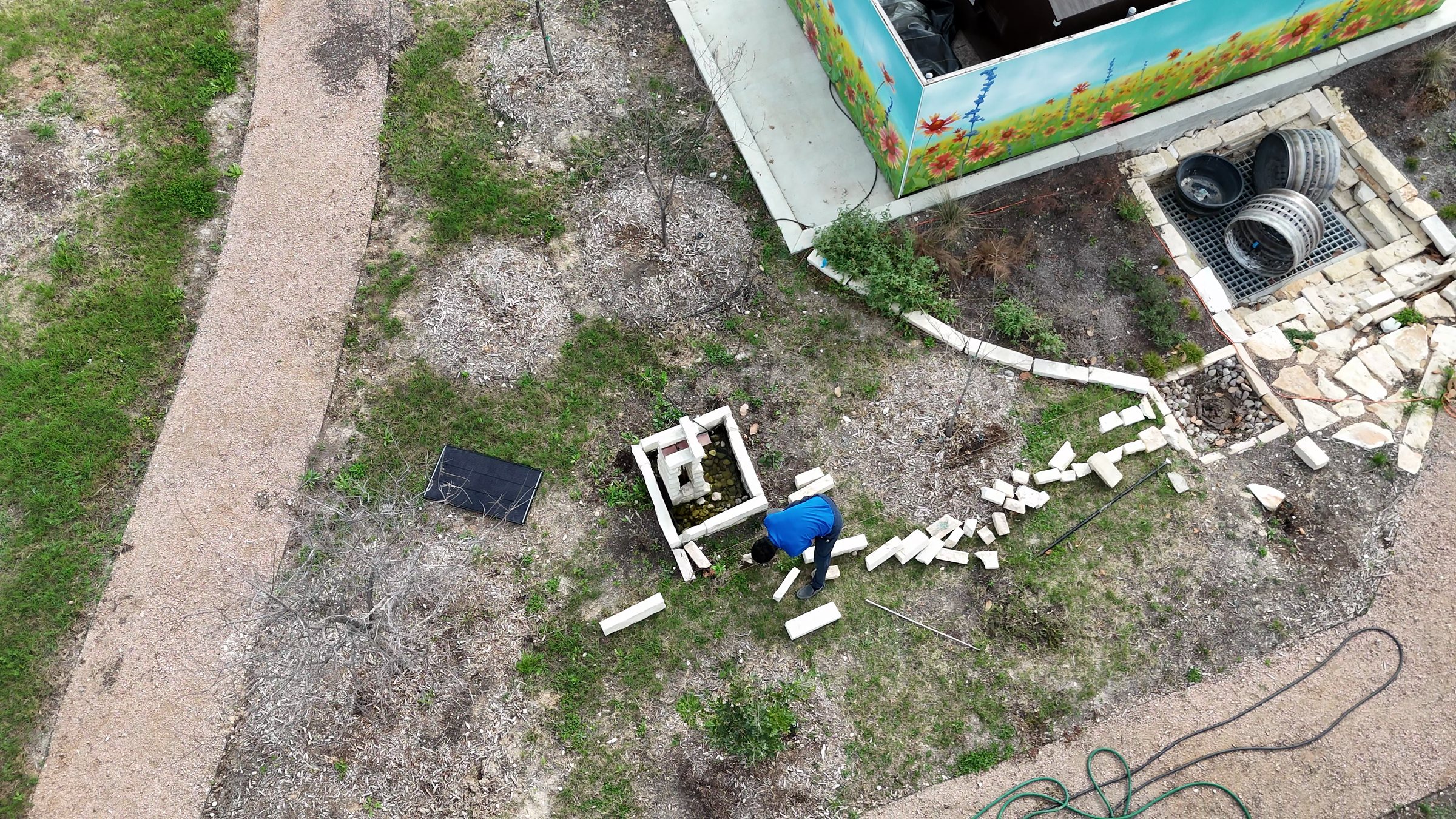 The court from the air in February: the cast basin, the limestone rill being laid toward the basins under the mural wall.