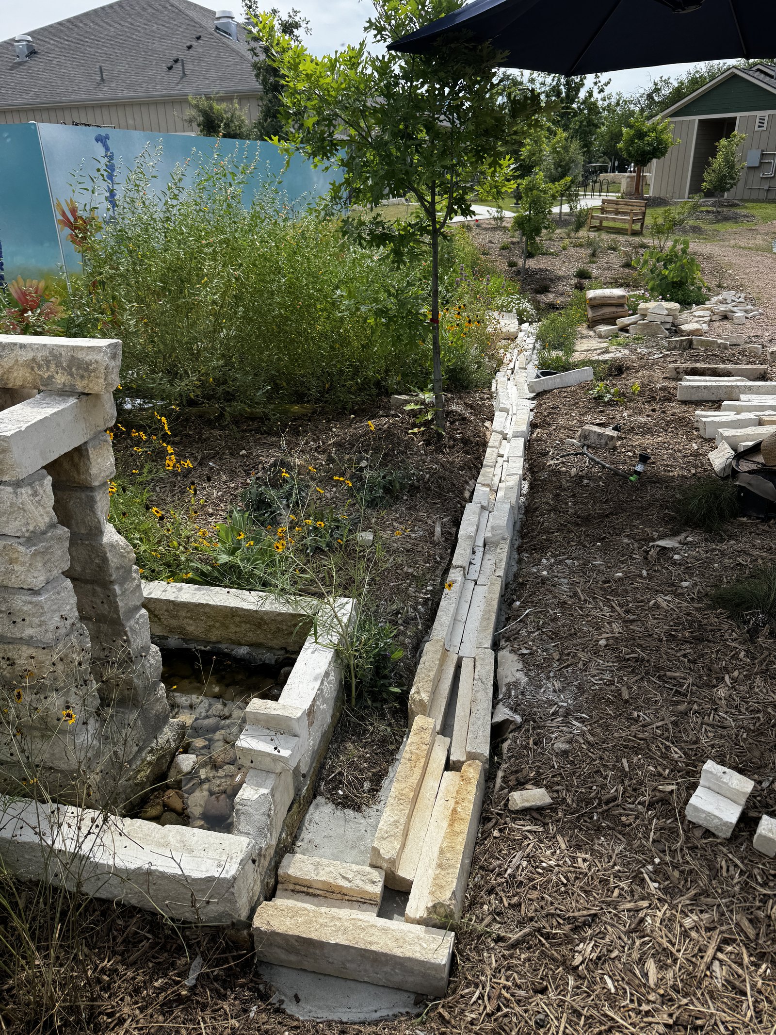 The limestone rill at Towne Twin being laid, block by block