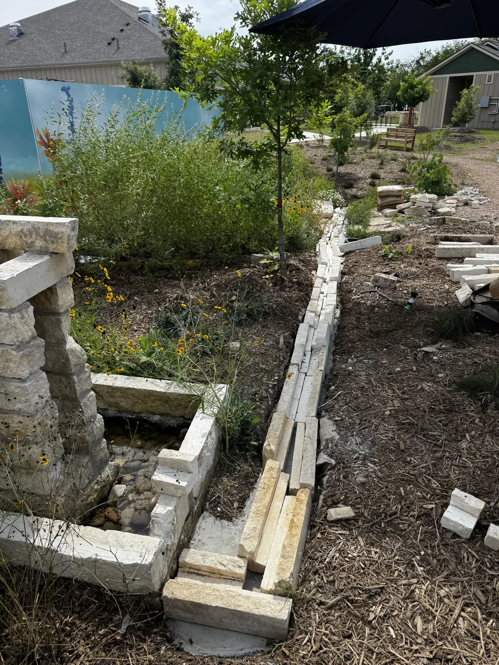The limestone rill running with water, lined block by block, the court beyond.