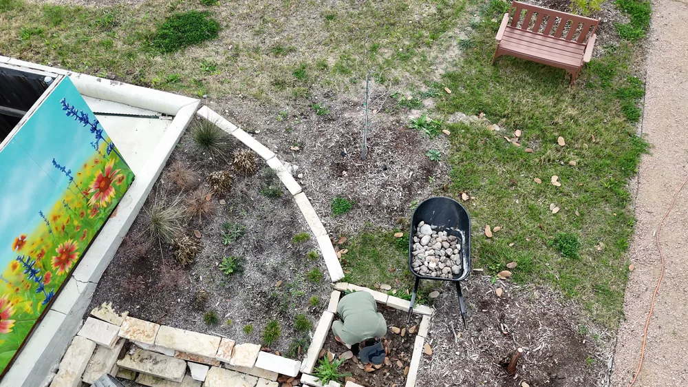 The mural wall and both basins from the air, the limestone rill leading in.