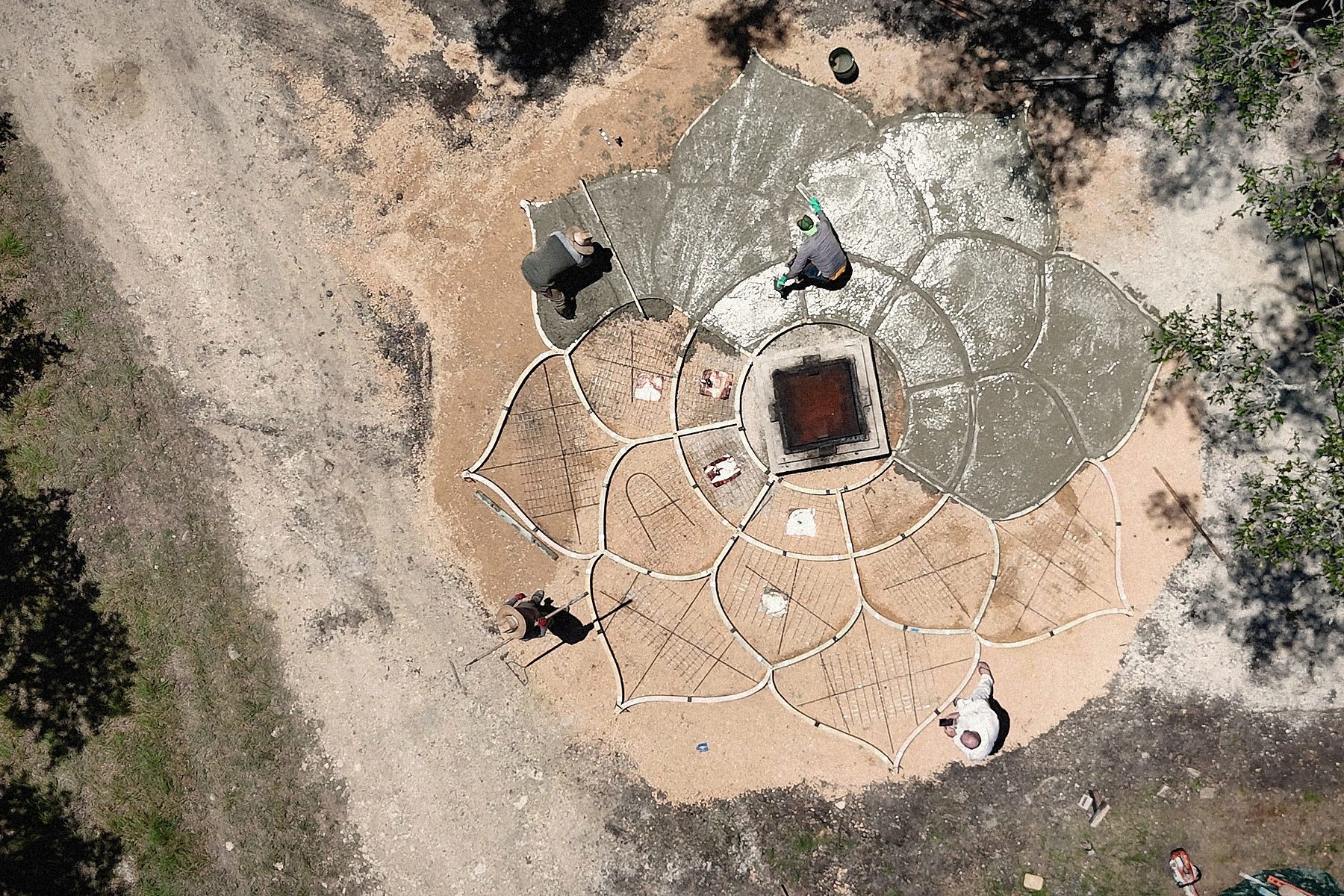 Half poured, from straight above: birch forms on one side, fresh concrete on the other.