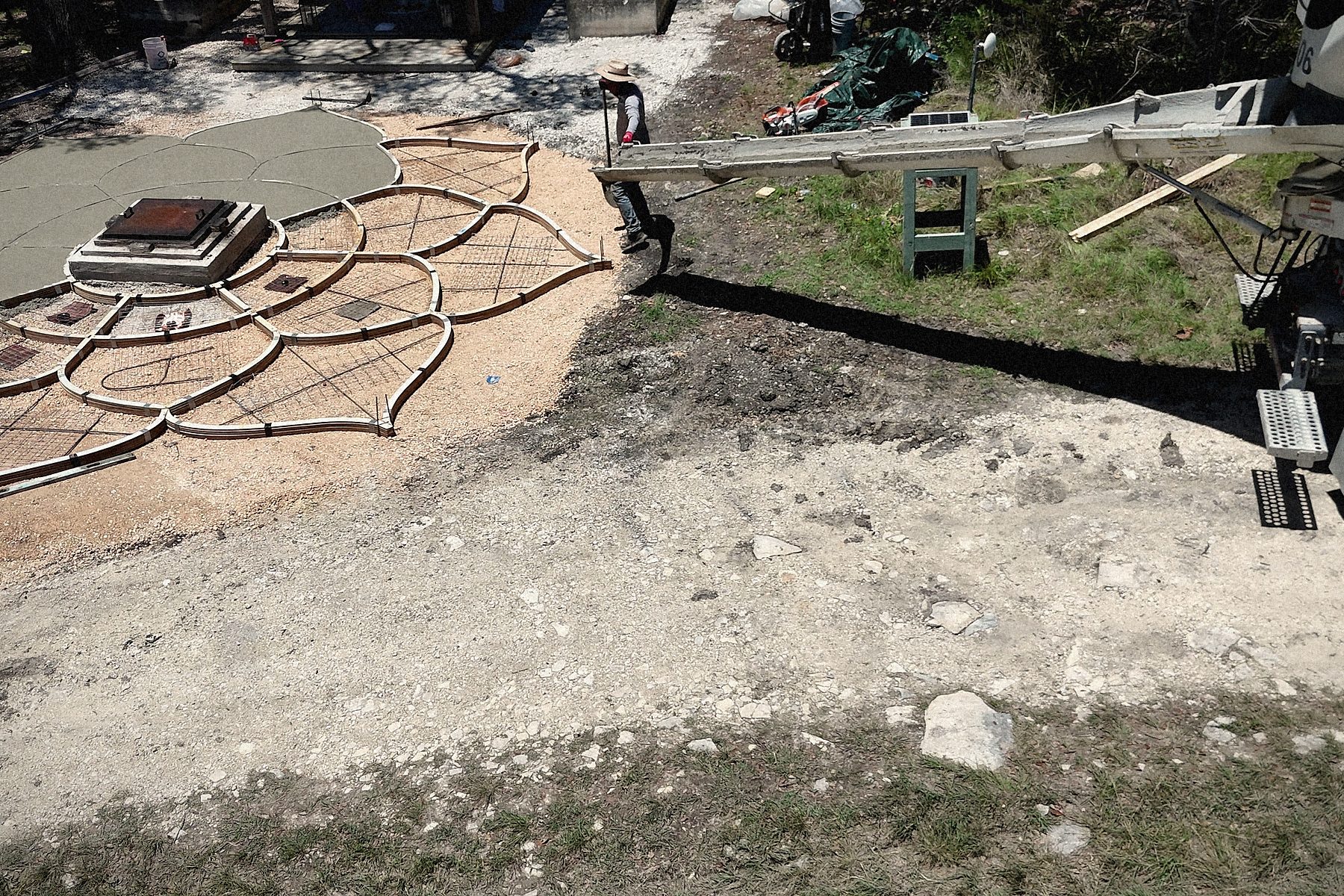 Nine cubic yards by chute: the truck at the edge of the site, the chute over the forms.