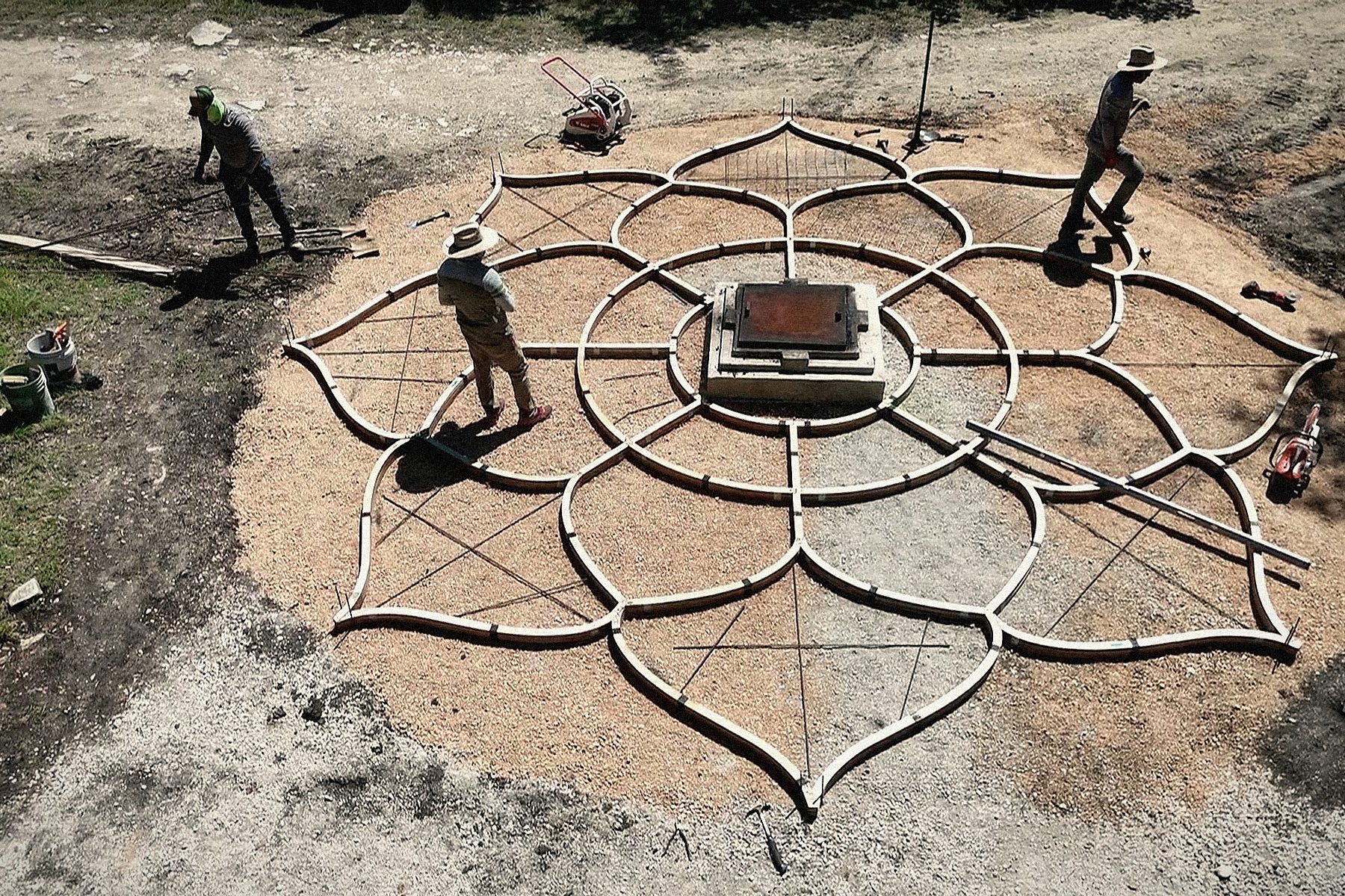The forms set on the prepared ground: one family of laminated birch ribs to each petal, the mesh going in.